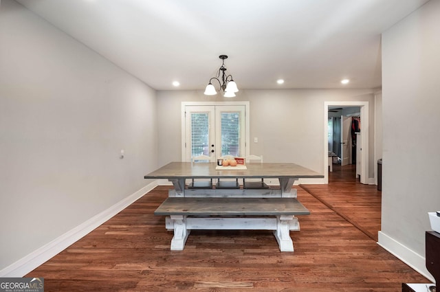 dining area with a notable chandelier, dark hardwood / wood-style flooring, and french doors