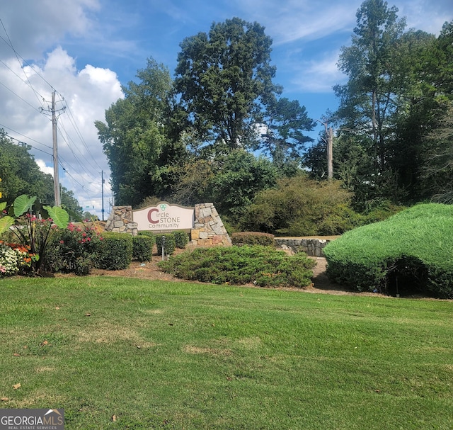 community / neighborhood sign featuring a yard