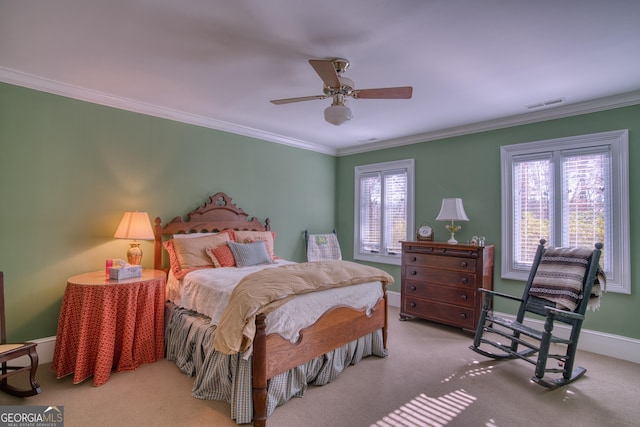 carpeted bedroom featuring ornamental molding, visible vents, and baseboards