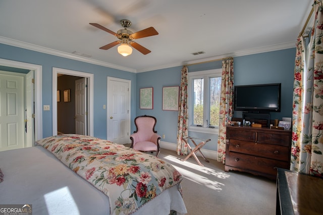 carpeted bedroom with ceiling fan, visible vents, baseboards, and ornamental molding