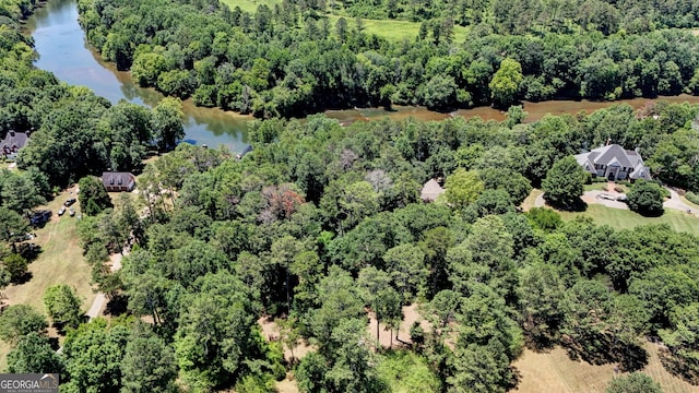 aerial view with a water view and a forest view