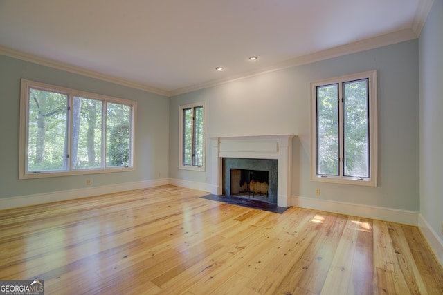 unfurnished living room with a fireplace, ornamental molding, and hardwood / wood-style floors