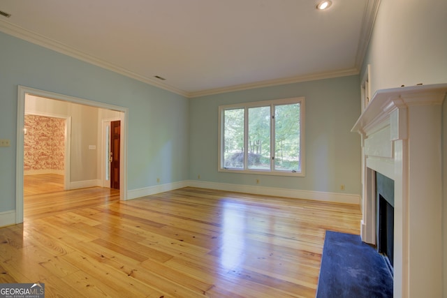 unfurnished living room featuring a fireplace, visible vents, light wood-style flooring, ornamental molding, and baseboards