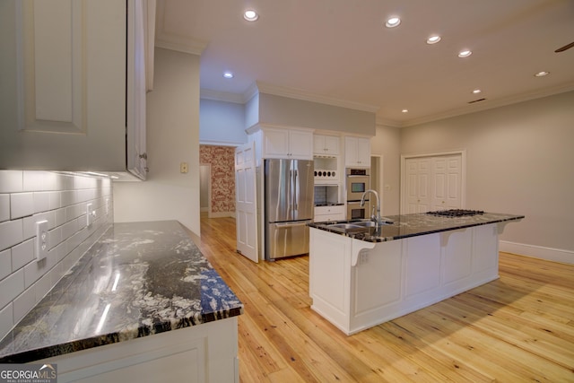 kitchen with light wood-style floors, white cabinetry, appliances with stainless steel finishes, and ornamental molding