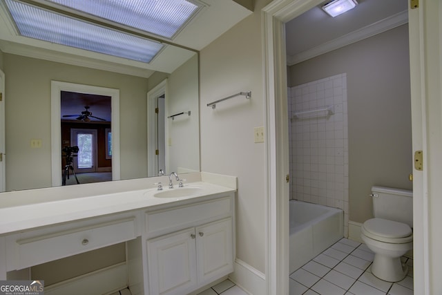 bathroom featuring baseboards, toilet, tile patterned flooring, crown molding, and vanity