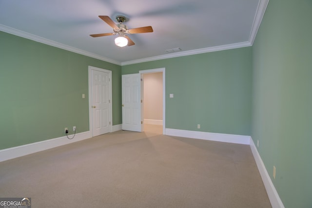 unfurnished bedroom with crown molding, light colored carpet, visible vents, a ceiling fan, and baseboards