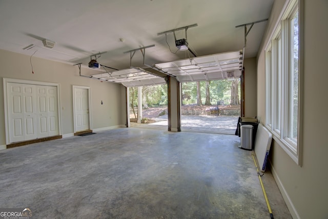 garage featuring a garage door opener and baseboards