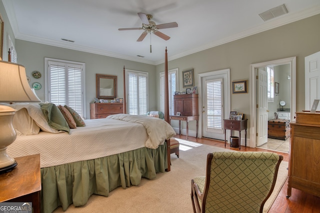 bedroom with multiple windows, visible vents, and ornamental molding