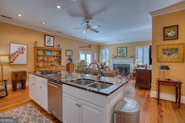 kitchen with a sink, visible vents, white cabinetry, dishwasher, and a center island with sink