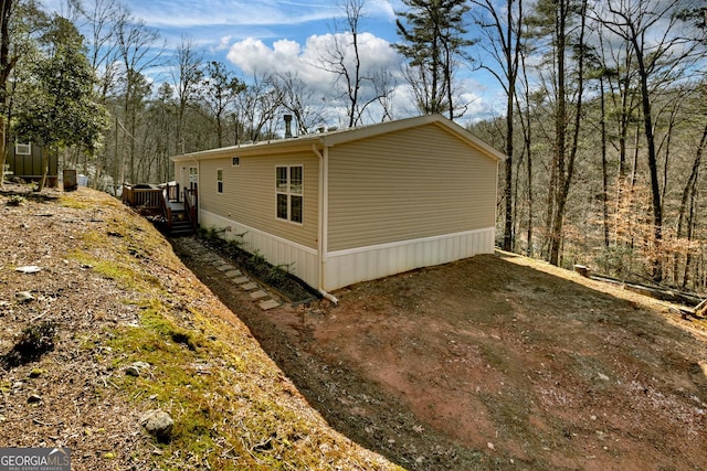 view of side of property featuring a deck