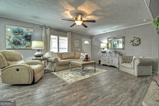 living room with a textured ceiling, hardwood / wood-style flooring, ceiling fan, and ornamental molding