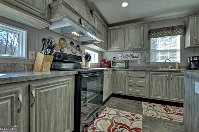 kitchen featuring sink, light wood-type flooring, black range with electric cooktop, and custom exhaust hood