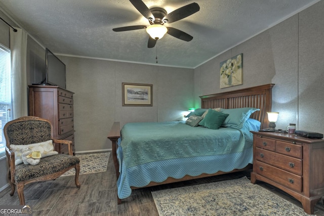 bedroom featuring ceiling fan, crown molding, and a textured ceiling