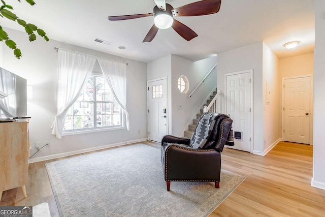 sitting room with light hardwood / wood-style flooring and ceiling fan