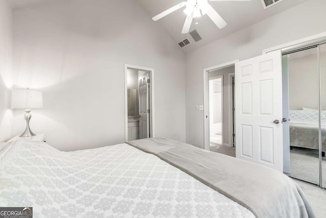 carpeted bedroom featuring ceiling fan, a closet, high vaulted ceiling, and ensuite bathroom