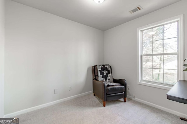 living area with light carpet