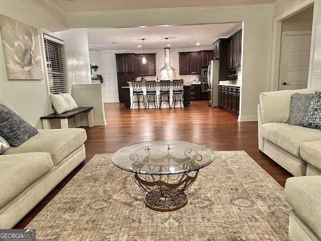 living room featuring crown molding and dark wood-type flooring