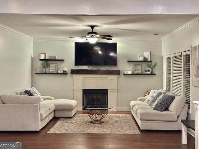 living room with dark hardwood / wood-style flooring, ceiling fan, and crown molding