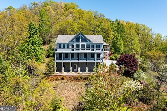 back of house featuring a balcony