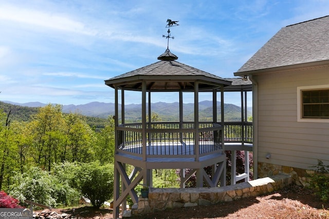 deck with a gazebo and a mountain view