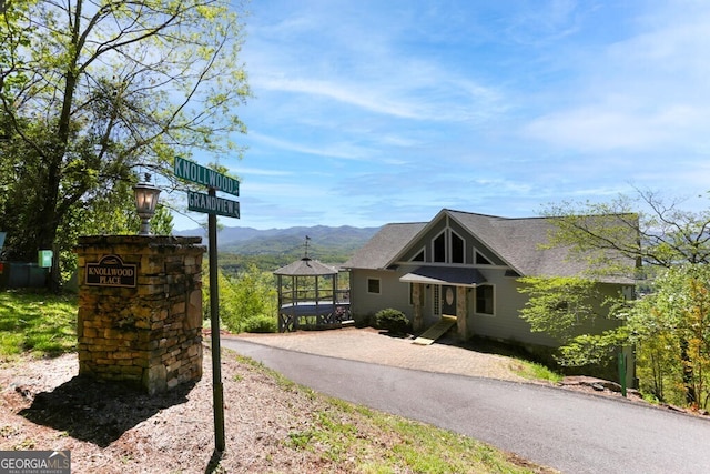 view of front facade featuring a mountain view and a gazebo