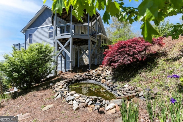 view of side of property with a wooden deck