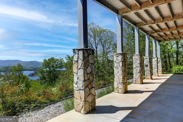 view of patio featuring a water and mountain view