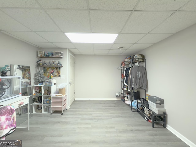 interior space featuring hardwood / wood-style flooring and a drop ceiling