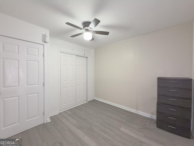 unfurnished bedroom featuring light hardwood / wood-style flooring and ceiling fan