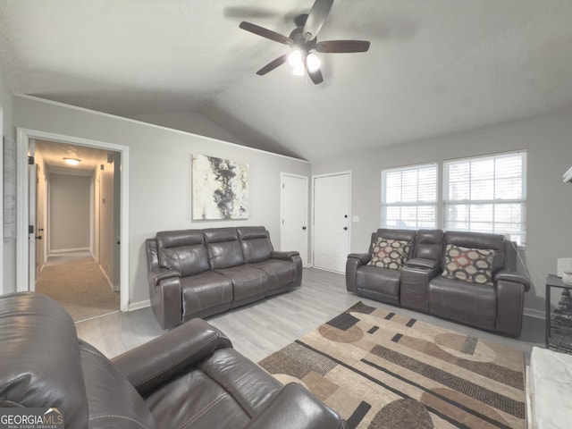 living room with light wood-type flooring, ceiling fan, and lofted ceiling