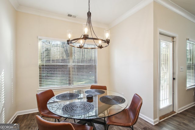 dining area with ornamental molding, dark hardwood / wood-style floors, and a chandelier