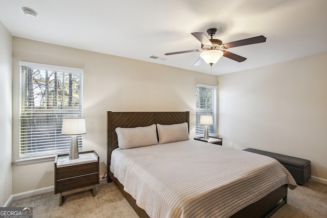 bedroom featuring light colored carpet and ceiling fan