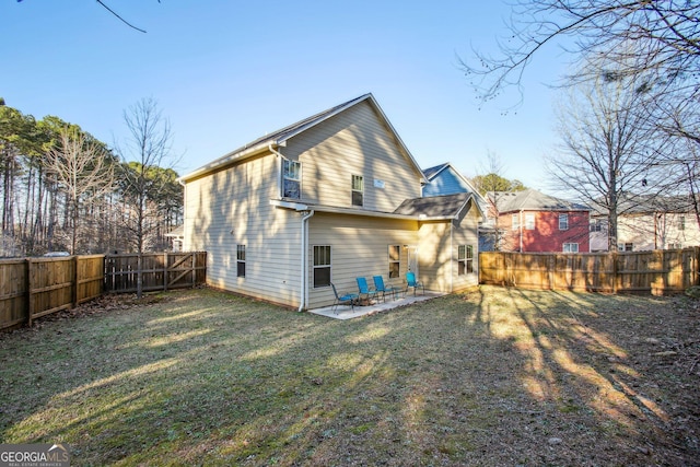 back of house with a patio and a lawn