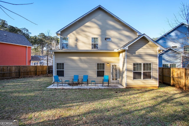 rear view of house featuring a yard and a patio area