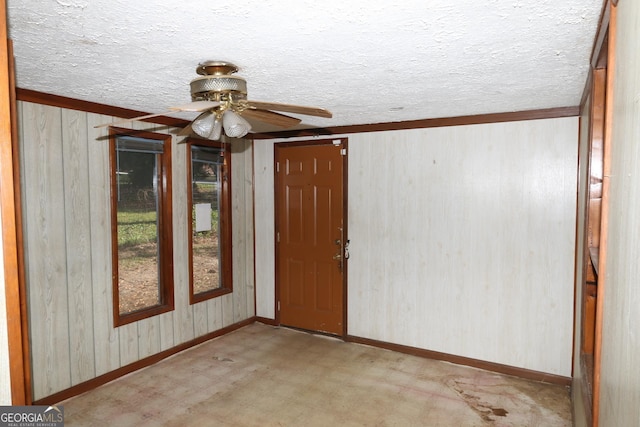 empty room featuring light carpet, a textured ceiling, and ceiling fan