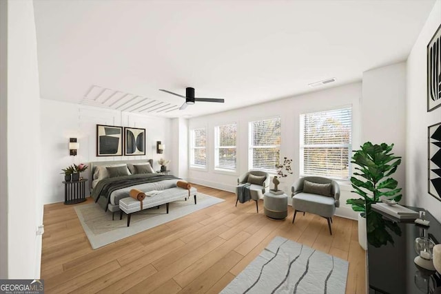 bedroom with ceiling fan and light hardwood / wood-style flooring