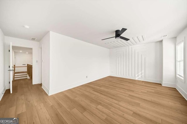 empty room featuring ceiling fan and light hardwood / wood-style flooring