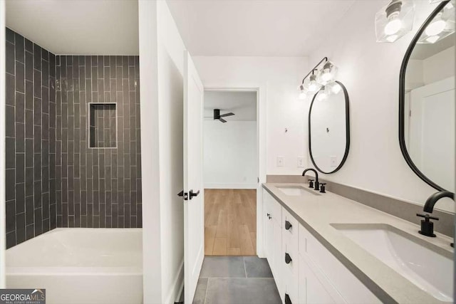 bathroom featuring tiled shower / bath combo, vanity, tile patterned floors, and ceiling fan