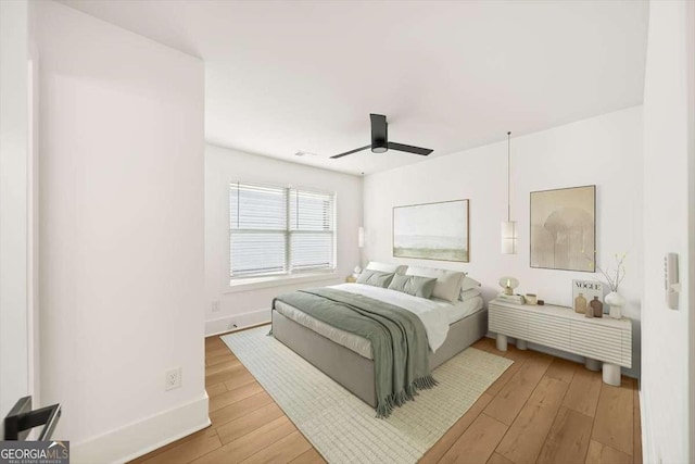 bedroom with ceiling fan and light wood-type flooring