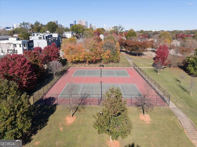 view of sport court with a lawn