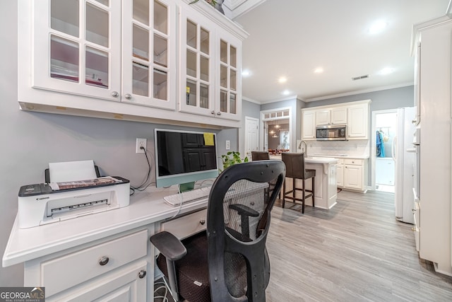 office featuring crown molding and light hardwood / wood-style floors