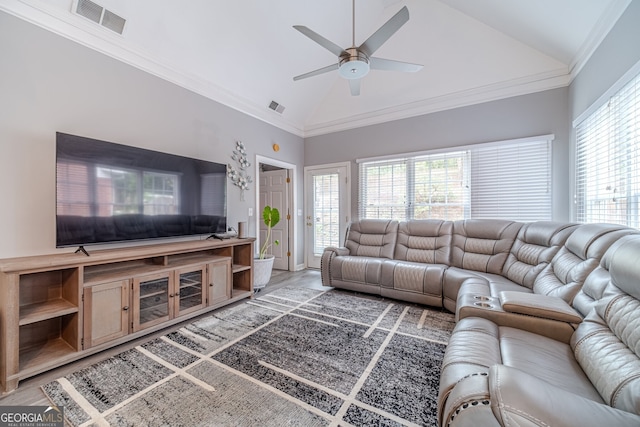 living room with hardwood / wood-style floors, crown molding, ceiling fan, and lofted ceiling