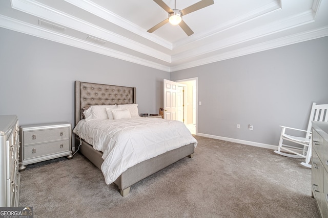 carpeted bedroom featuring ceiling fan, crown molding, and a tray ceiling