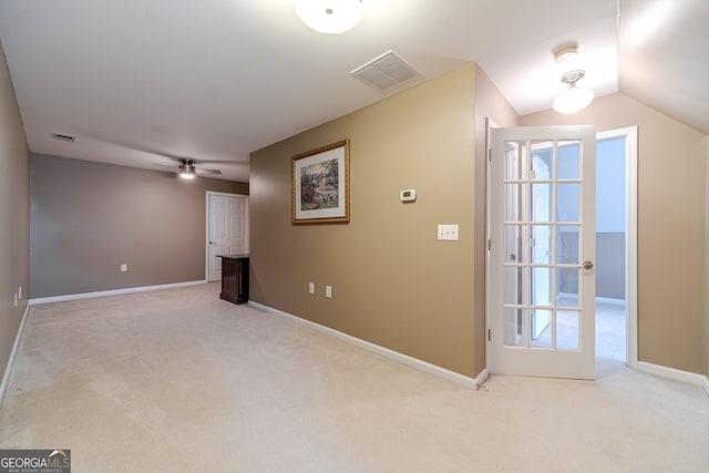 interior space with light carpet, plenty of natural light, ceiling fan, and lofted ceiling