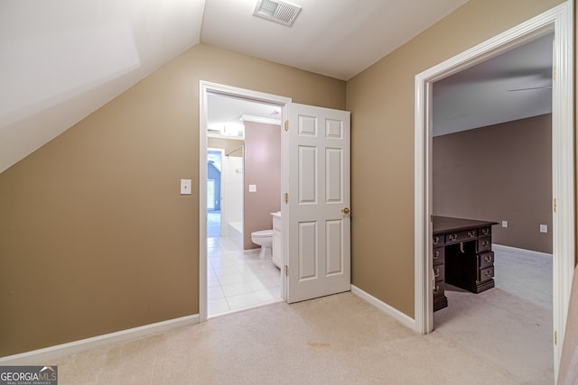 interior space with light colored carpet and vaulted ceiling