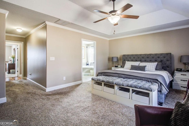 bedroom featuring crown molding, ceiling fan, carpet flooring, connected bathroom, and a tray ceiling