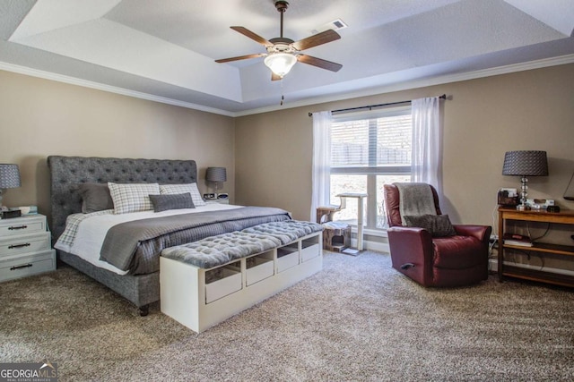 bedroom with visible vents, a raised ceiling, carpet, and crown molding