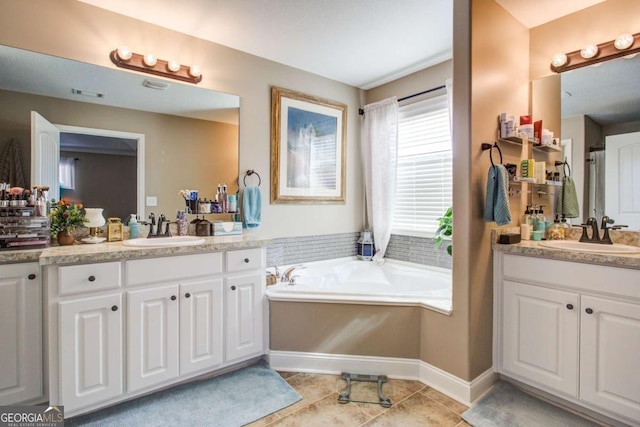 bathroom with vanity, tile patterned flooring, and a bathtub