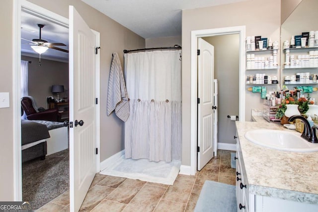 bathroom featuring tile patterned floors, a shower with curtain, connected bathroom, baseboards, and vanity