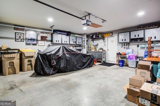 garage featuring a garage door opener and a workshop area